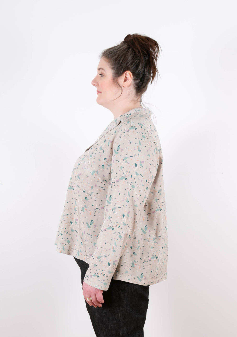 Side view of long sleeve Augusta Top in terrazzo print showing soft drape and relaxed fit.