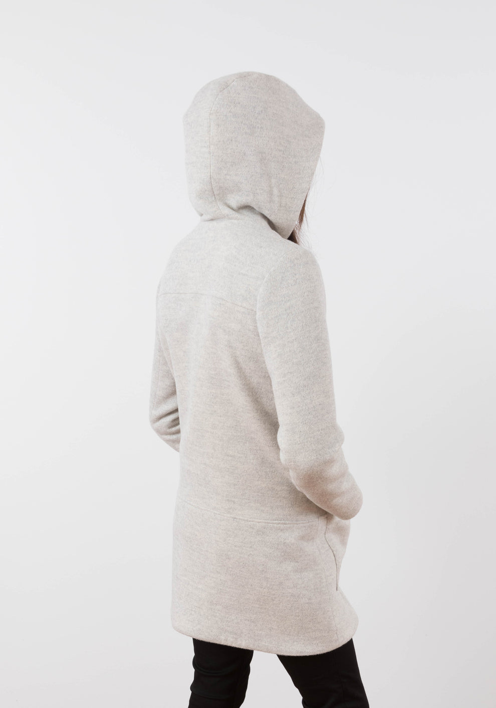 Back view of long Cascade Duffle Coat in heathered gray wool with hood worn up.