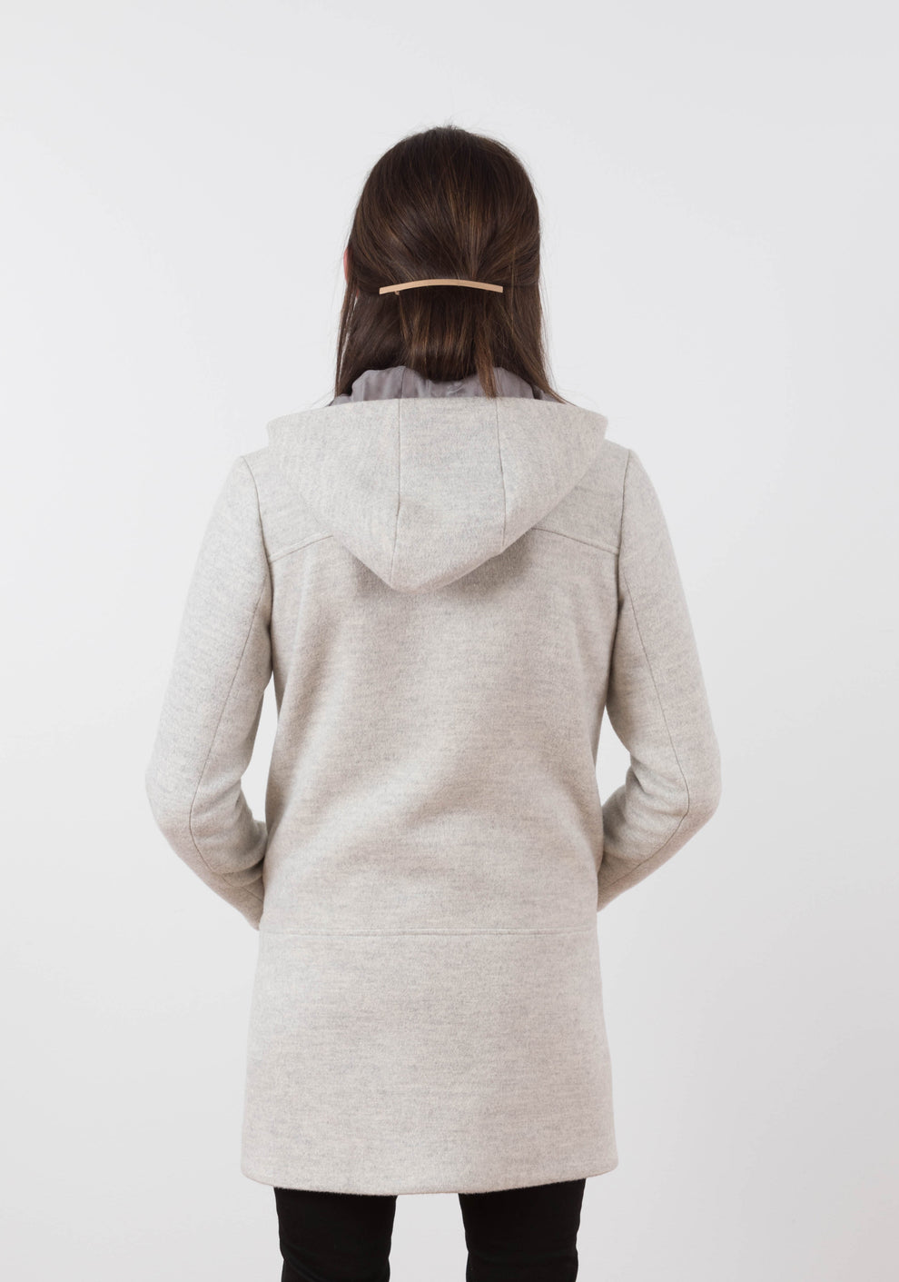 Back view of long Cascade Duffle Coat in heathered gray wool with hood and back yoke seam.