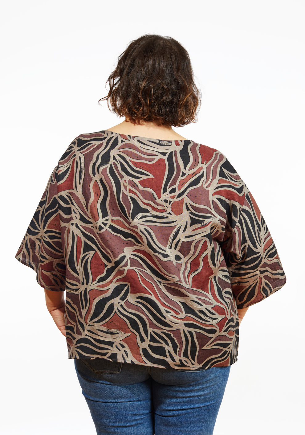 Back view of Corin Top in abstract batik print with wide sleeves and relaxed fit, worn by model.