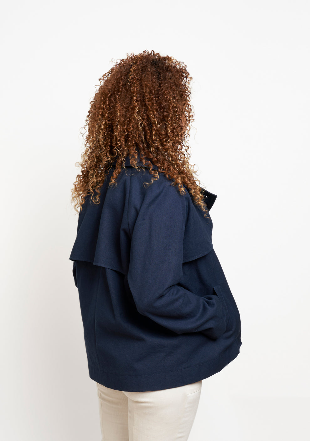 Cortland Trench View A back angled view showing relaxed fit and storm flap detail.