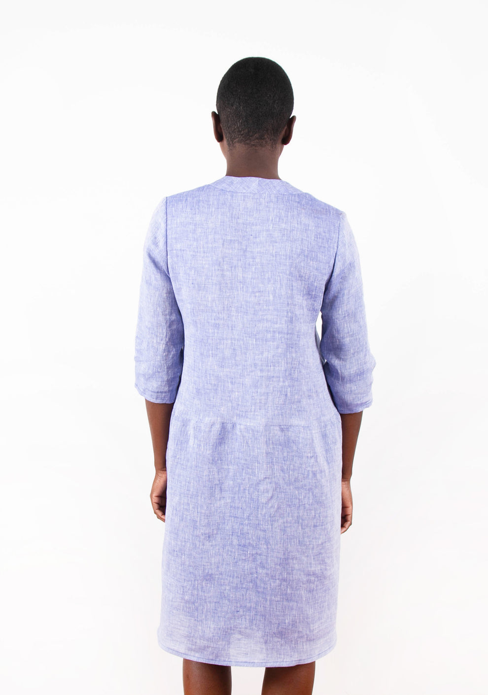 Back view of Felix Dress in blue linen, modeled with 3/4 sleeves.
