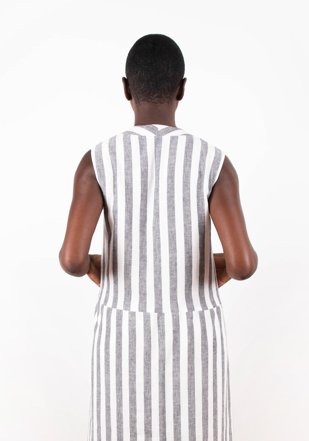 Back view of sleeveless Felix Dress in gray and white striped fabric.
