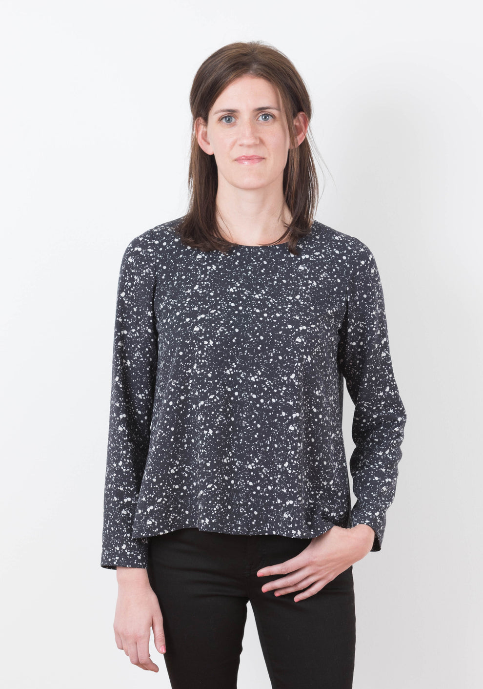 Model: Size 6, 5'8" | Front view of the Hadley Top in black and white speckled fabric with long sleeves, worn by model.