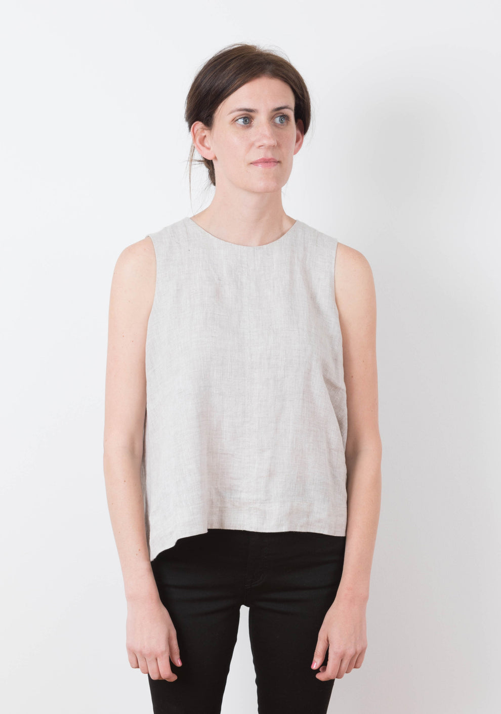 Front view of sleeveless Hadley Top in light linen with jewel neckline, worn by model.