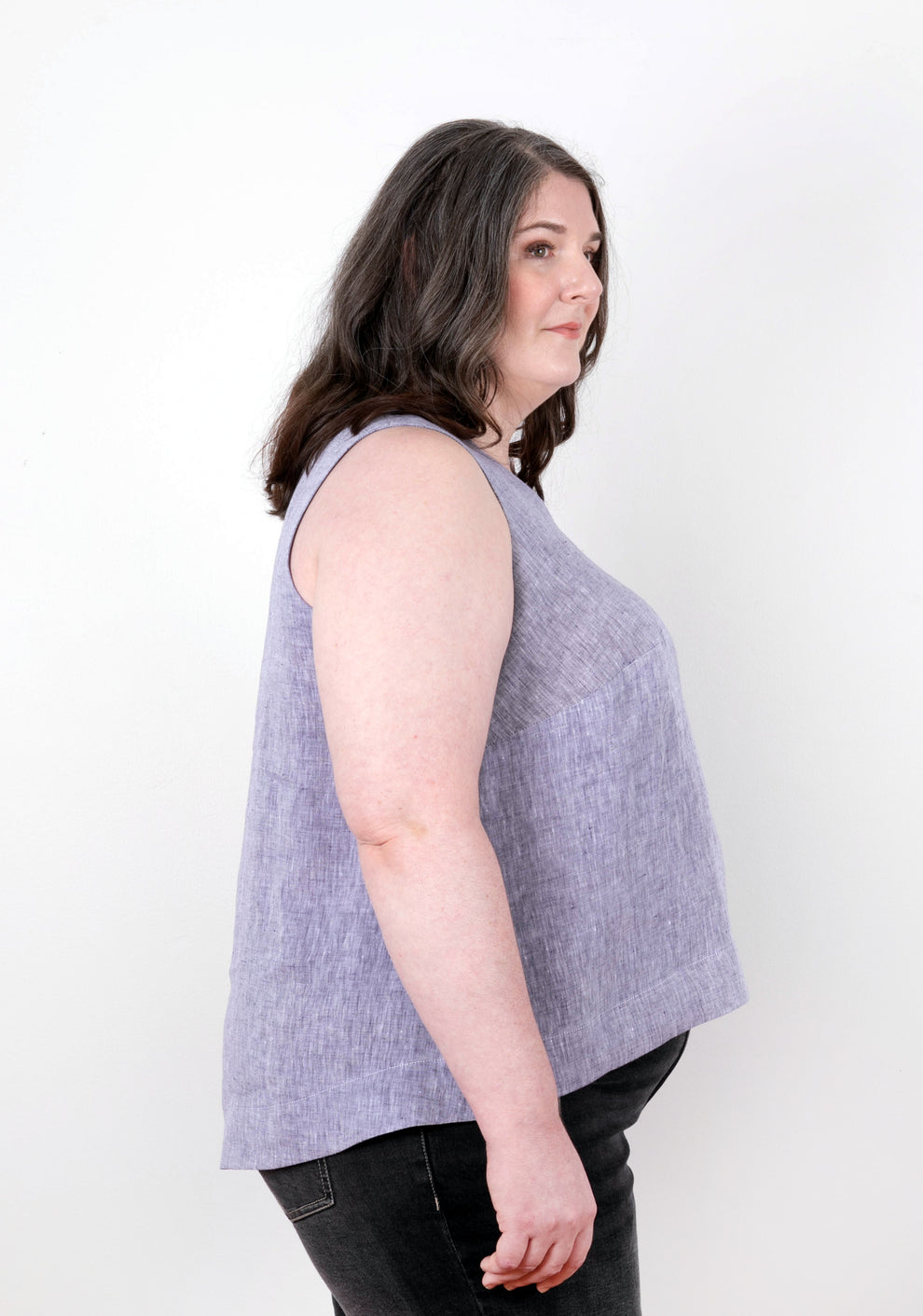 Side view of sleeveless lilac Hadley Top on model, showing gentle flare and hem curve.