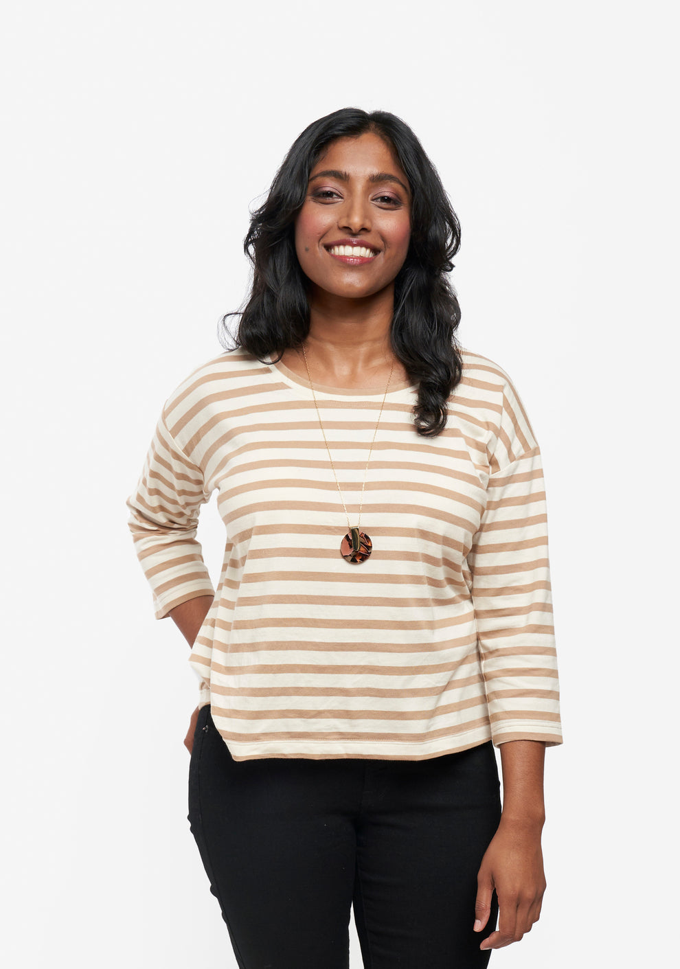 Model in hip length Hemlock Tee with 3/4 sleeves and beige stripes, styled with black pants.