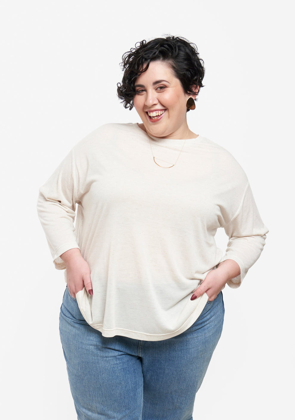 Model wearing tunic length Hemlock Tee with long sleeves in natural color and jeans.