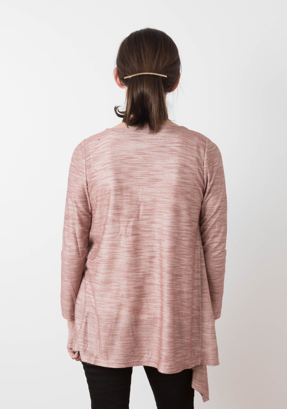 Back view of model wearing the rose Lark Cardigan, showing long hem and clean neckline.