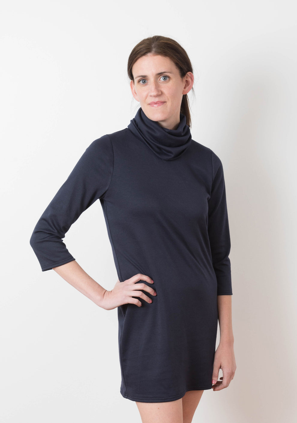 Model wearing navy Lark Dress with cowl neck and 3/4 sleeves, front view.