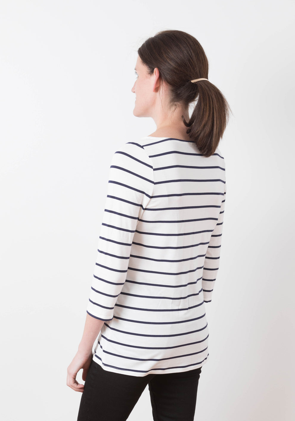 Model wearing Lark Tee with 3/4 sleeves and boat neckline, back view.