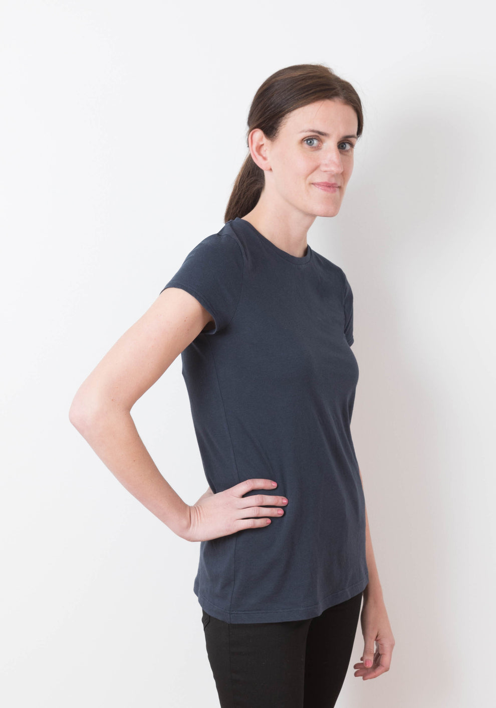 Model wearing Lark Tee with short sleeves and crew neckline, side view.