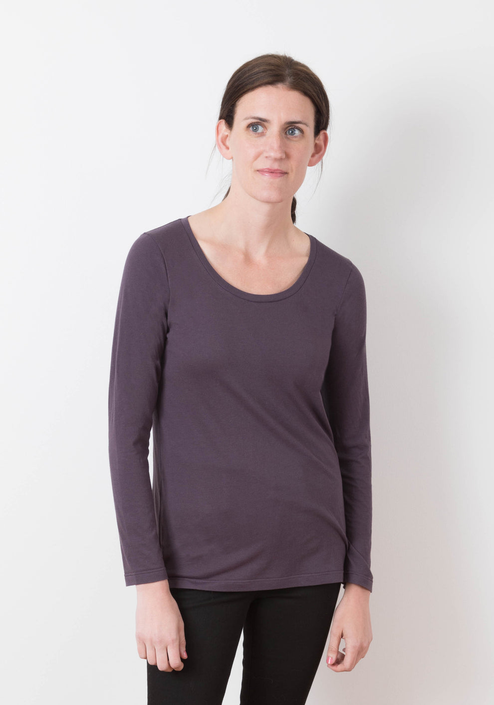 Model wearing Lark Tee with long sleeves and scoop neckline, front view.