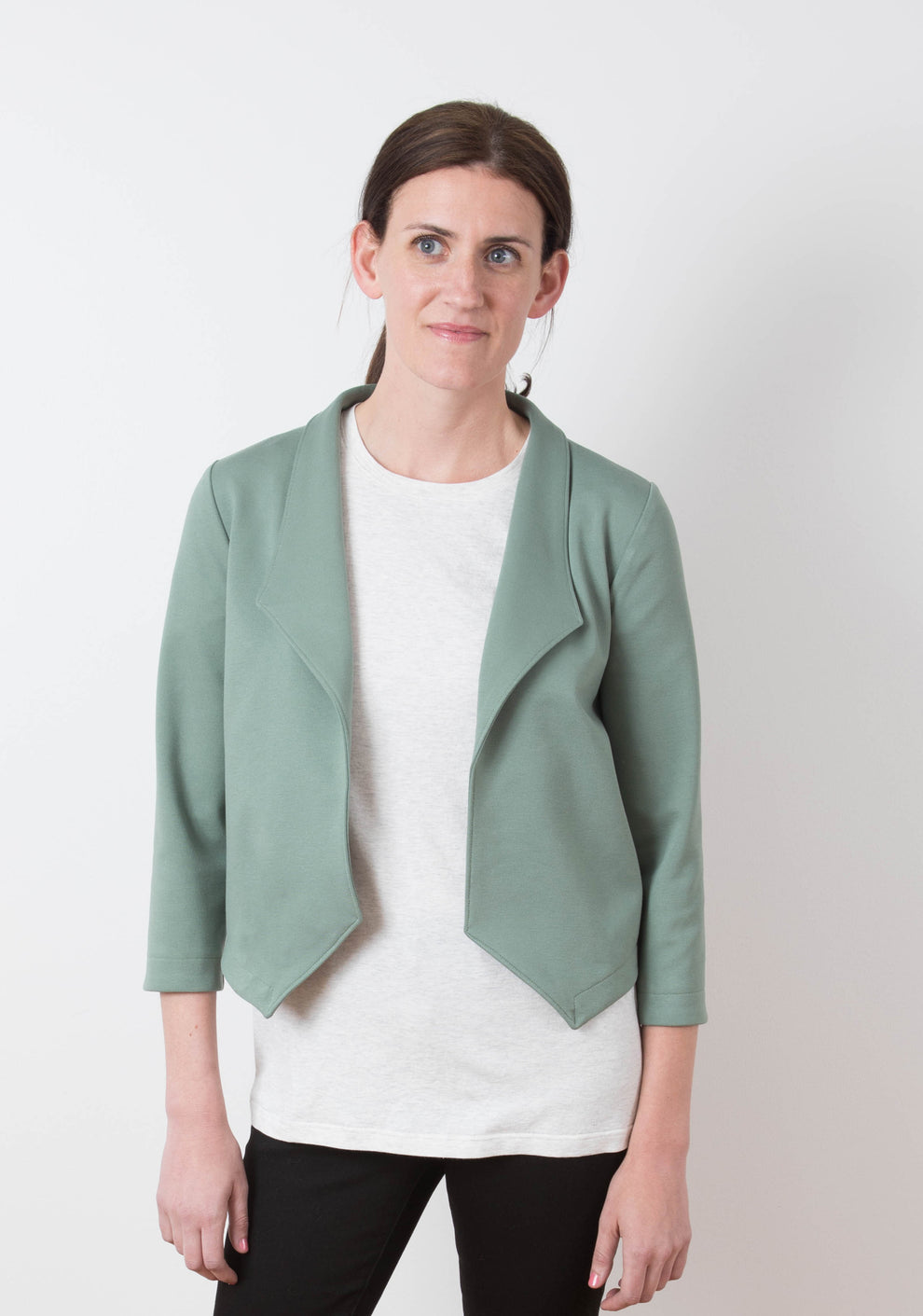 Model wearing Morris Blazer in sage ponte knit fabric, front view with arms relaxed.