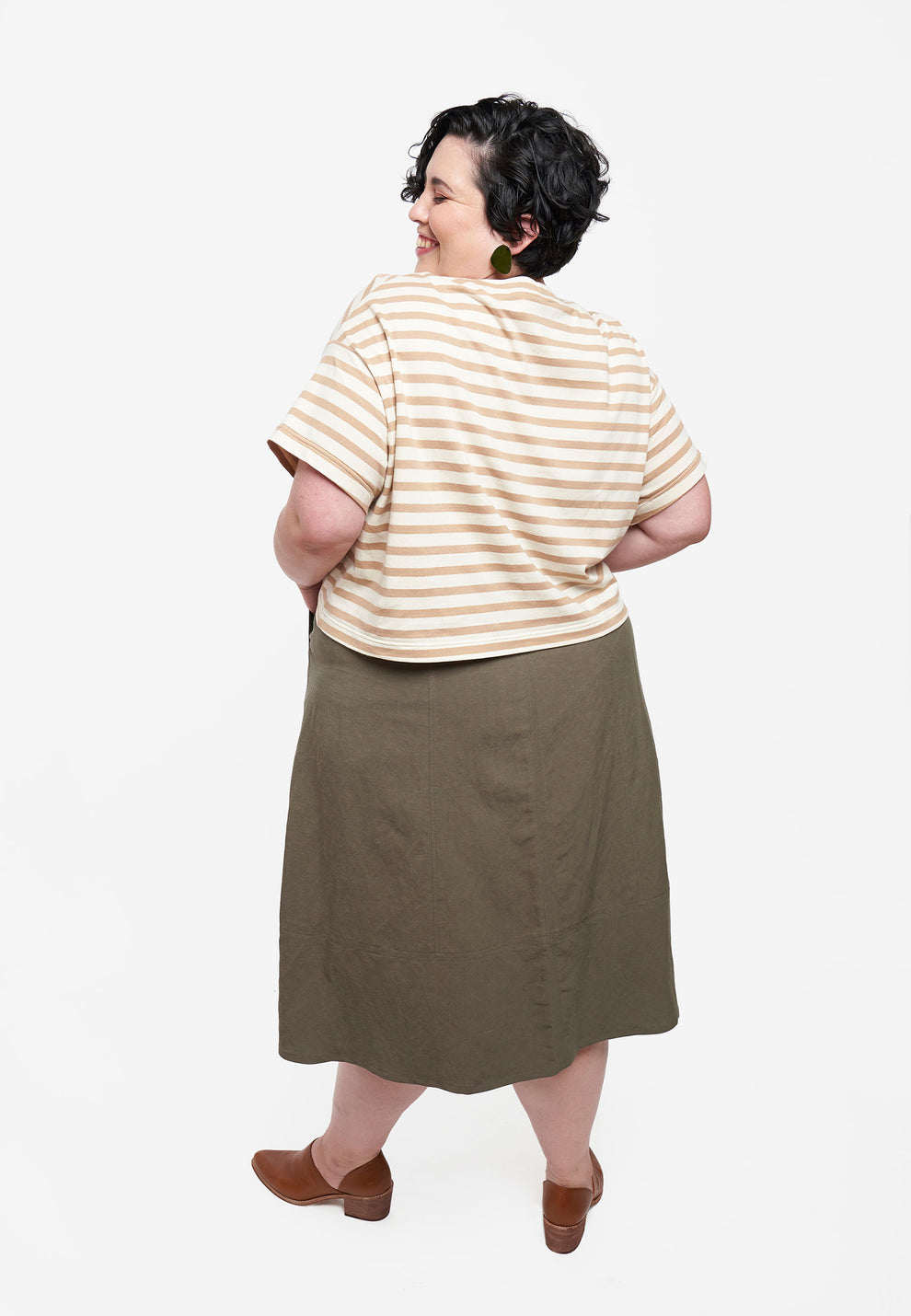 Back view of Reed Skirt in olive fabric showing back panel shaping and hemline curve.