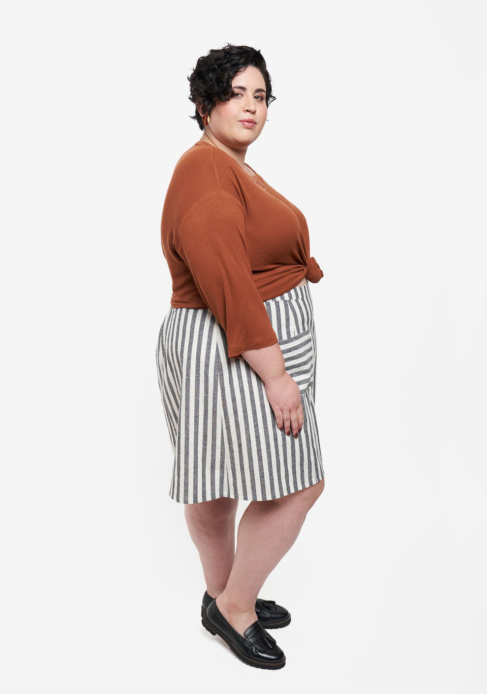 Side view of Reed Skirt in striped fabric showing A-line silhouette and pocket detail.