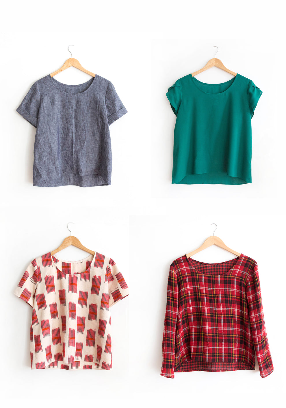 Four Scout Tee samples with sleeve add-ons hanging on hangers.