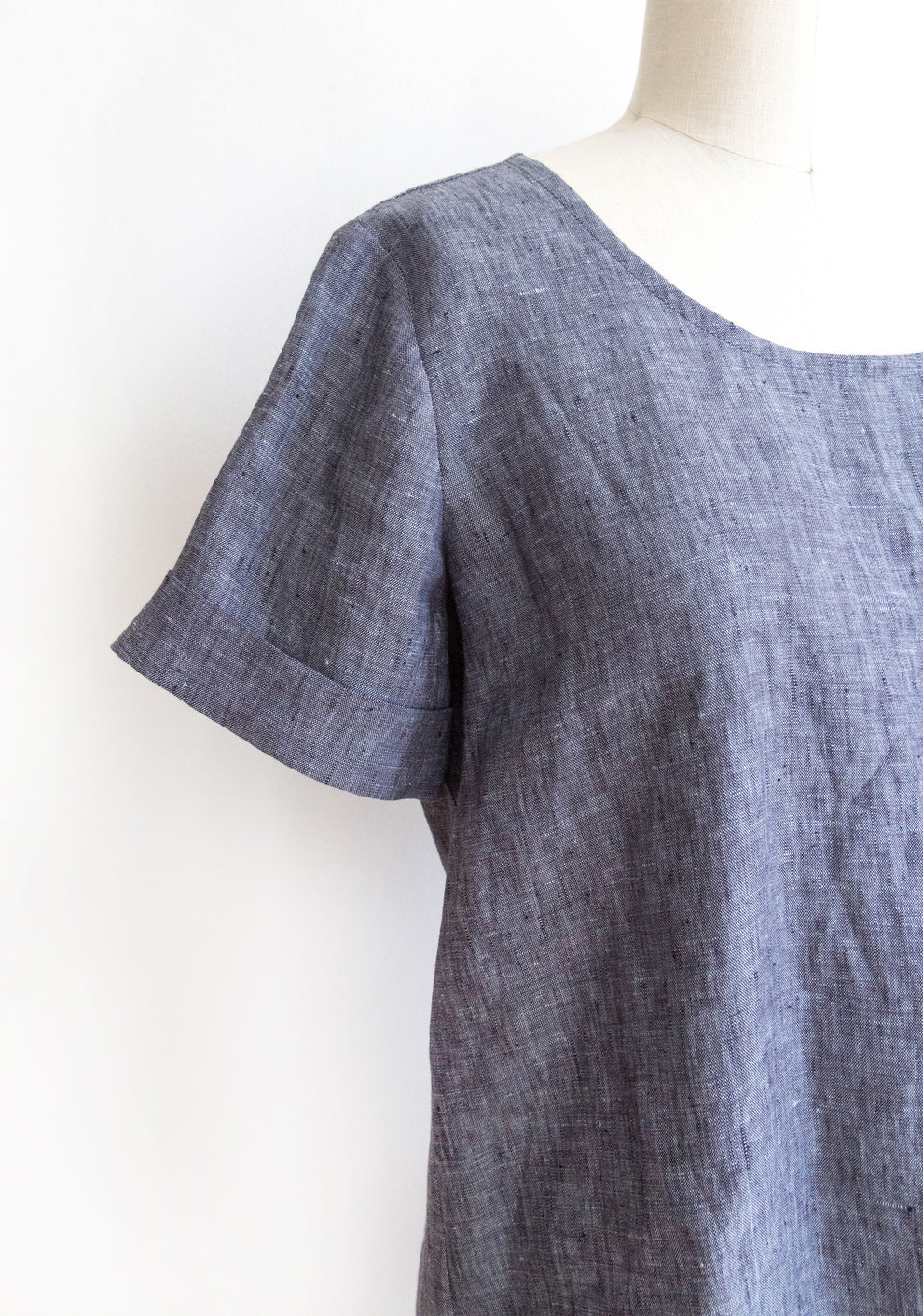 Close-up of Scout Tee short sleeve add-on in chambray fabric on dress form.