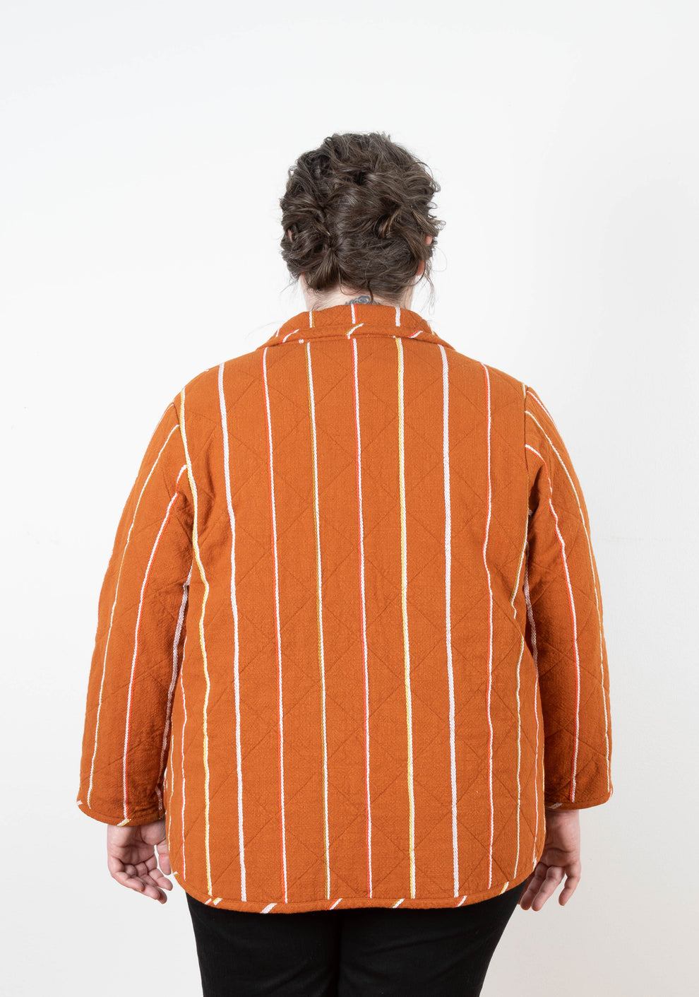 Back view of the Tamarack Jacket in orange striped fabric with collar add-on, size 0-32.