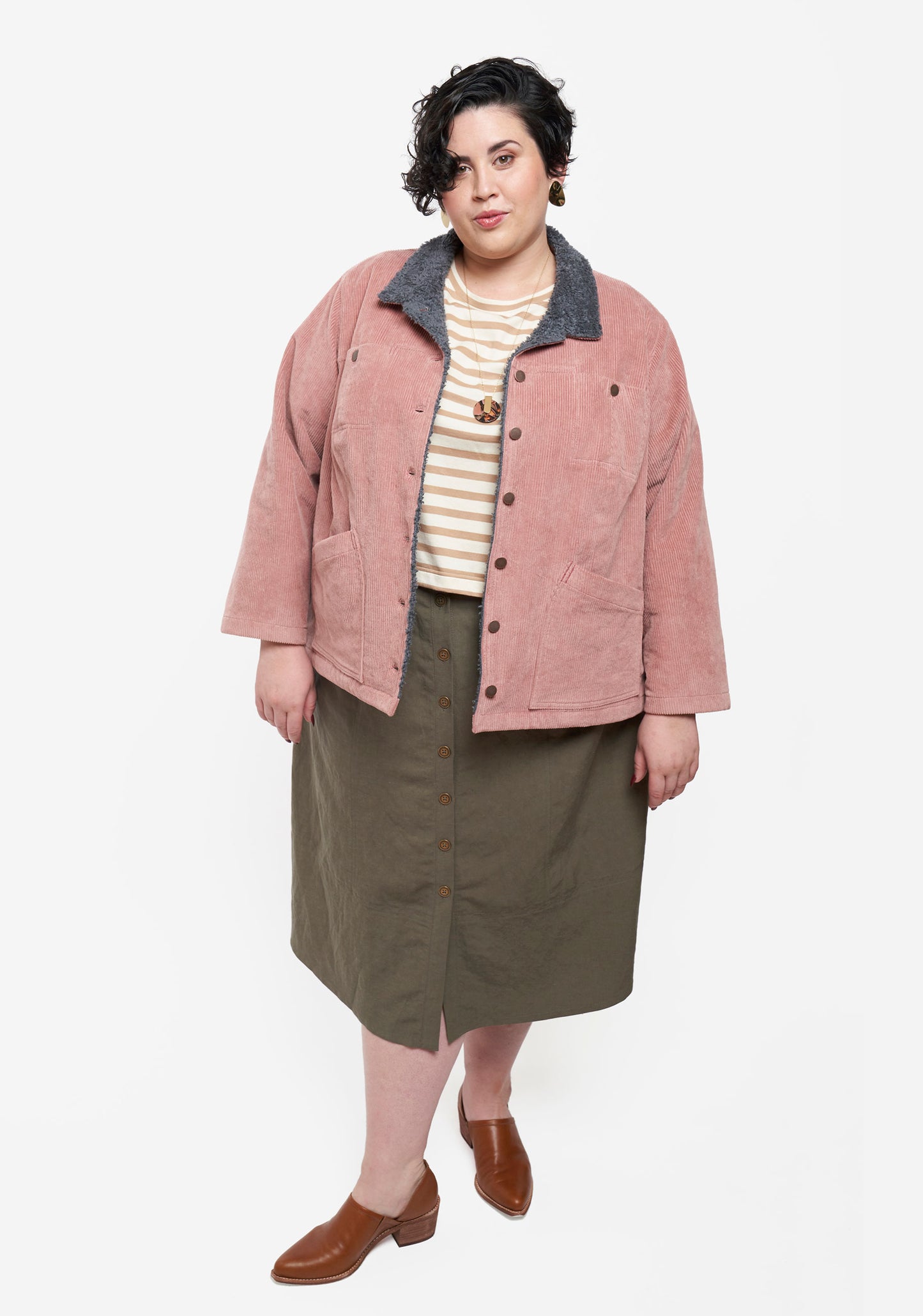Front view of model wearing Thayer Jacket layered over striped tee and olive skirt.