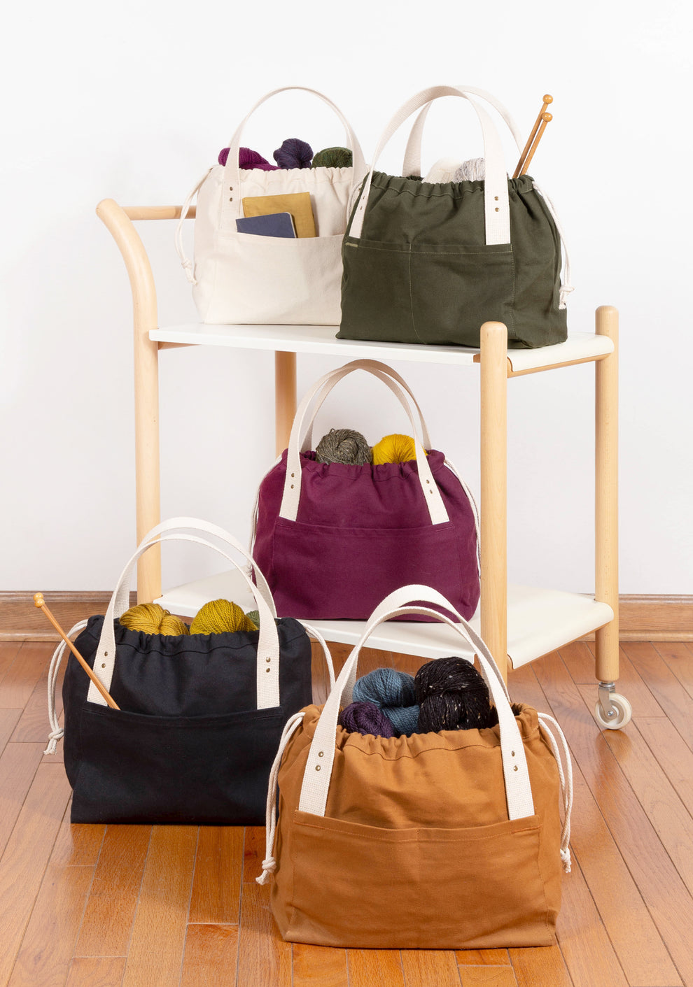 Side view of Town Bag with drawstring pulled open to reveal interior space.