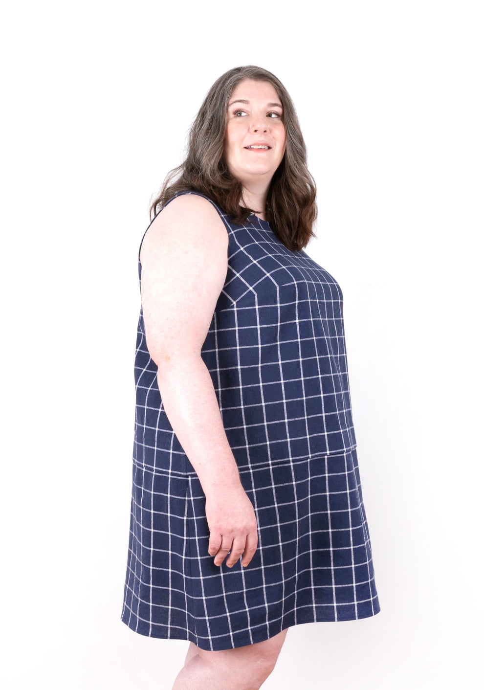 Angled front view of Willow Dress showing sleeveless silhouette and check fabric pattern.