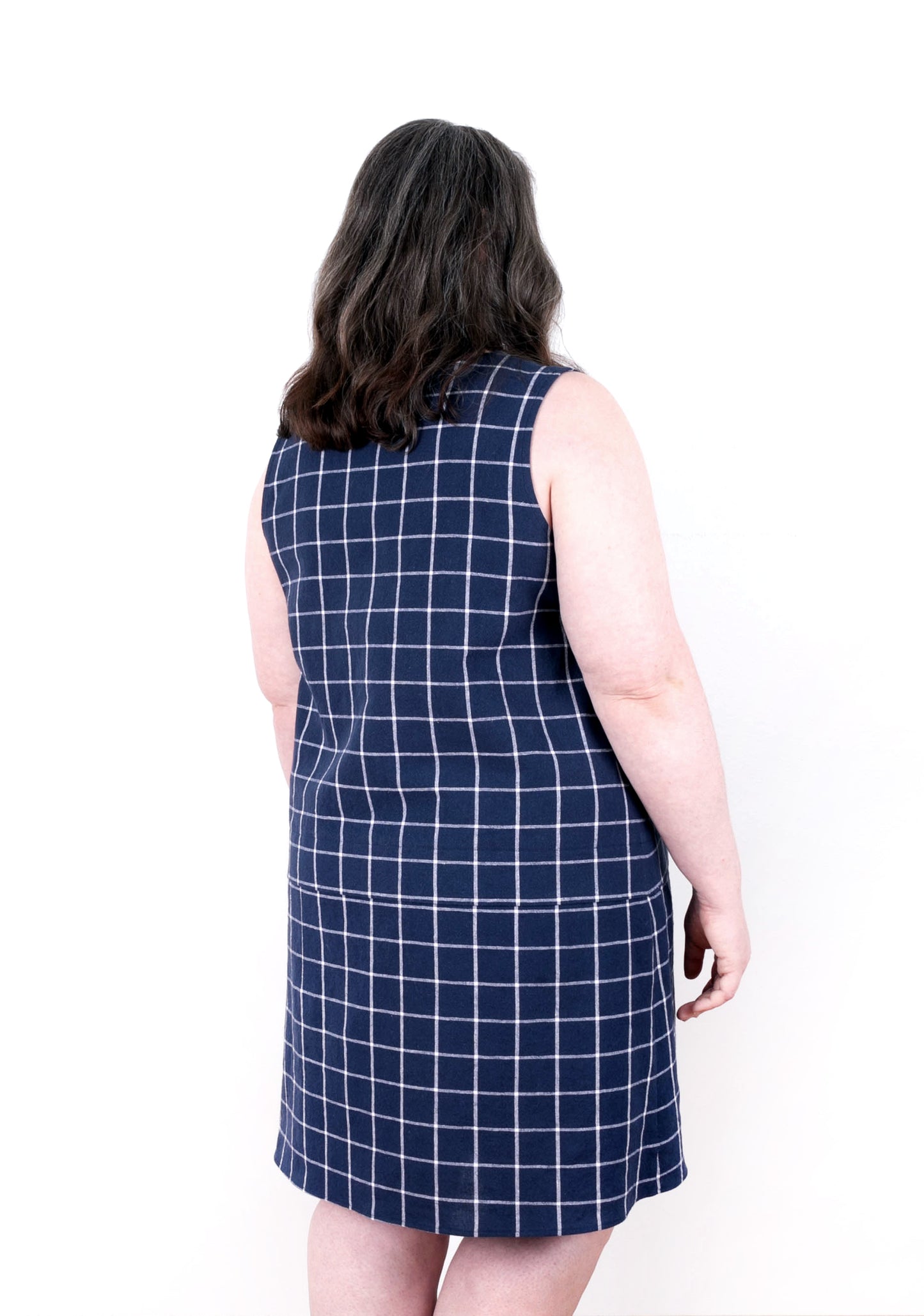 Back view of model wearing navy check Willow Dress showing drop waist seam.