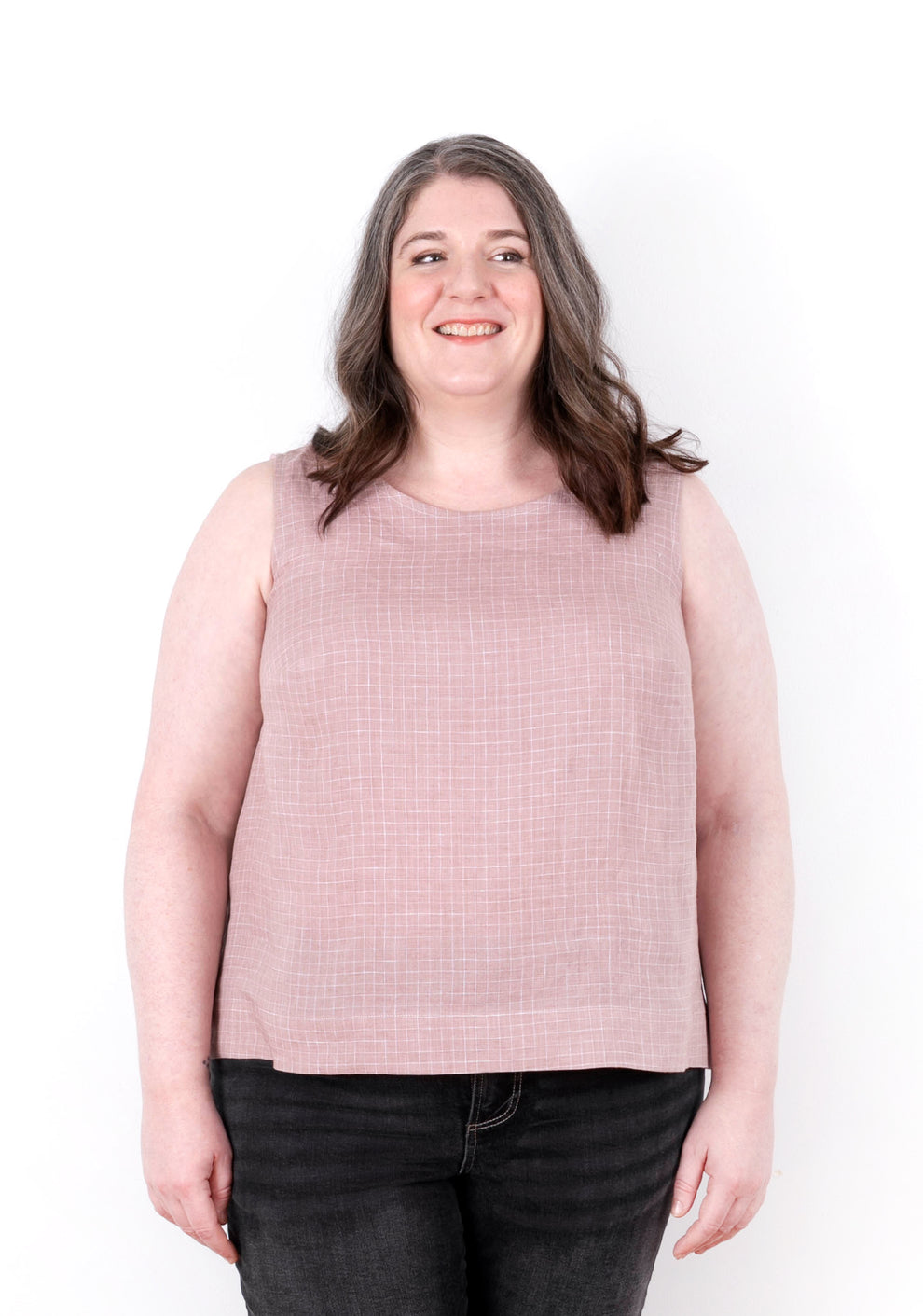 Model smiling while wearing Willow Tank in pink check fabric, front view.