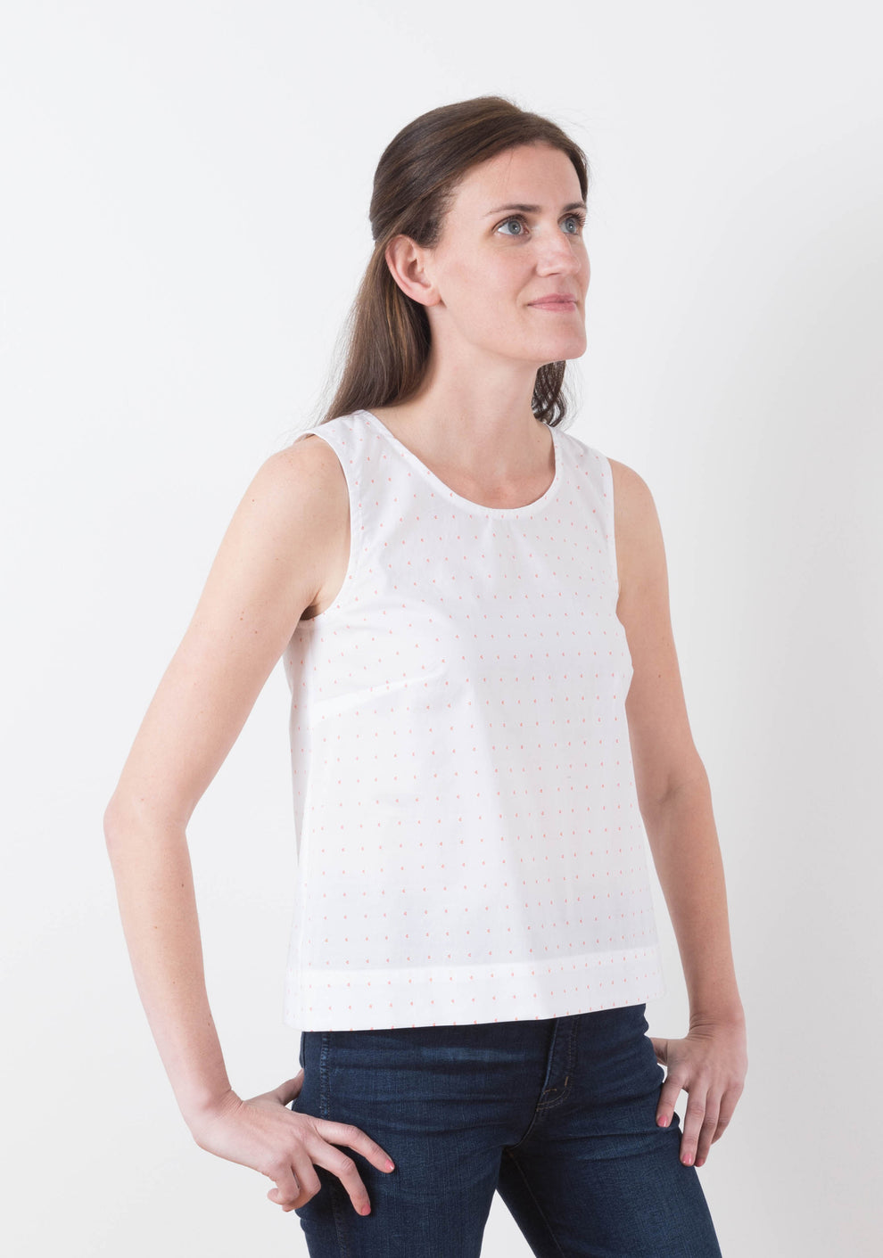Side view of sleeveless Willow Top in white print fabric, View A, worn by model.
